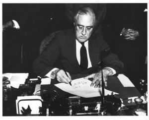 President Franklin D. Roosevelt signing the declaration of war against Japan. - National Archives and Records Administration
